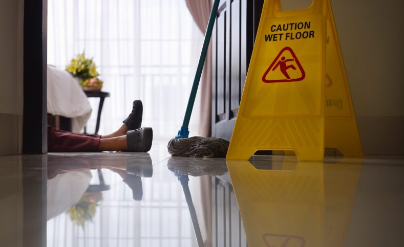 housemaid had accident at work while cleaning floor in hotel room. Side view, low angle